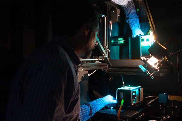 Aerospace scientist tests an AeroCube